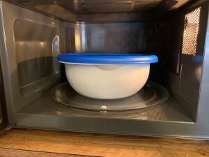 Microwave the bowl of popping corn for about 3 minutes or until done. Microwaving popcorn in a bowl.