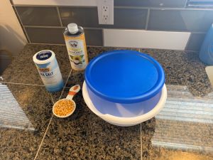 Microwave popcorn ingredients. Popcorn kernels, bowl, and seasonings.