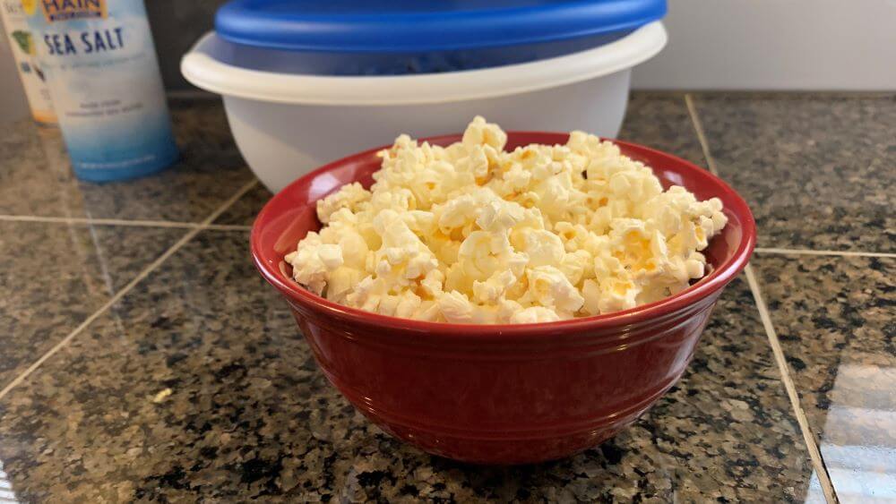 A red bowl of perfectly cooked popcorn.