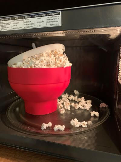 A bursting overflow of microwaved popcorn using white kernels. A bursting overflow of microwaved popcorn using white kernels in the Rapid Brands popper.