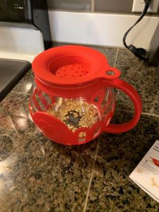 Pour the kernels into the bowl and replace lid on top.